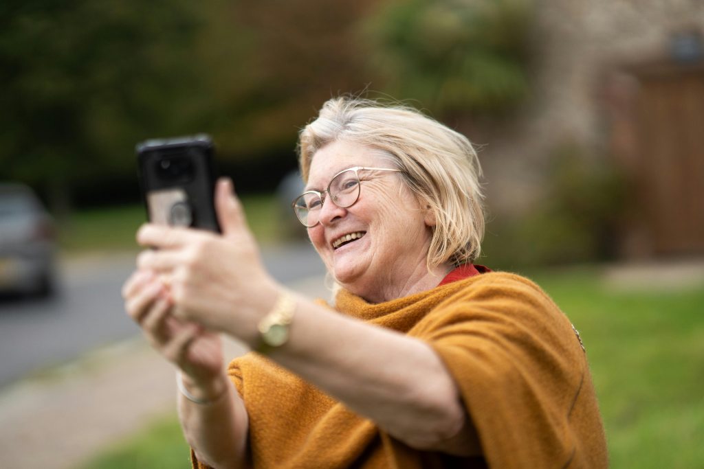 Smiling Woman Taking Selfie with Smartphone